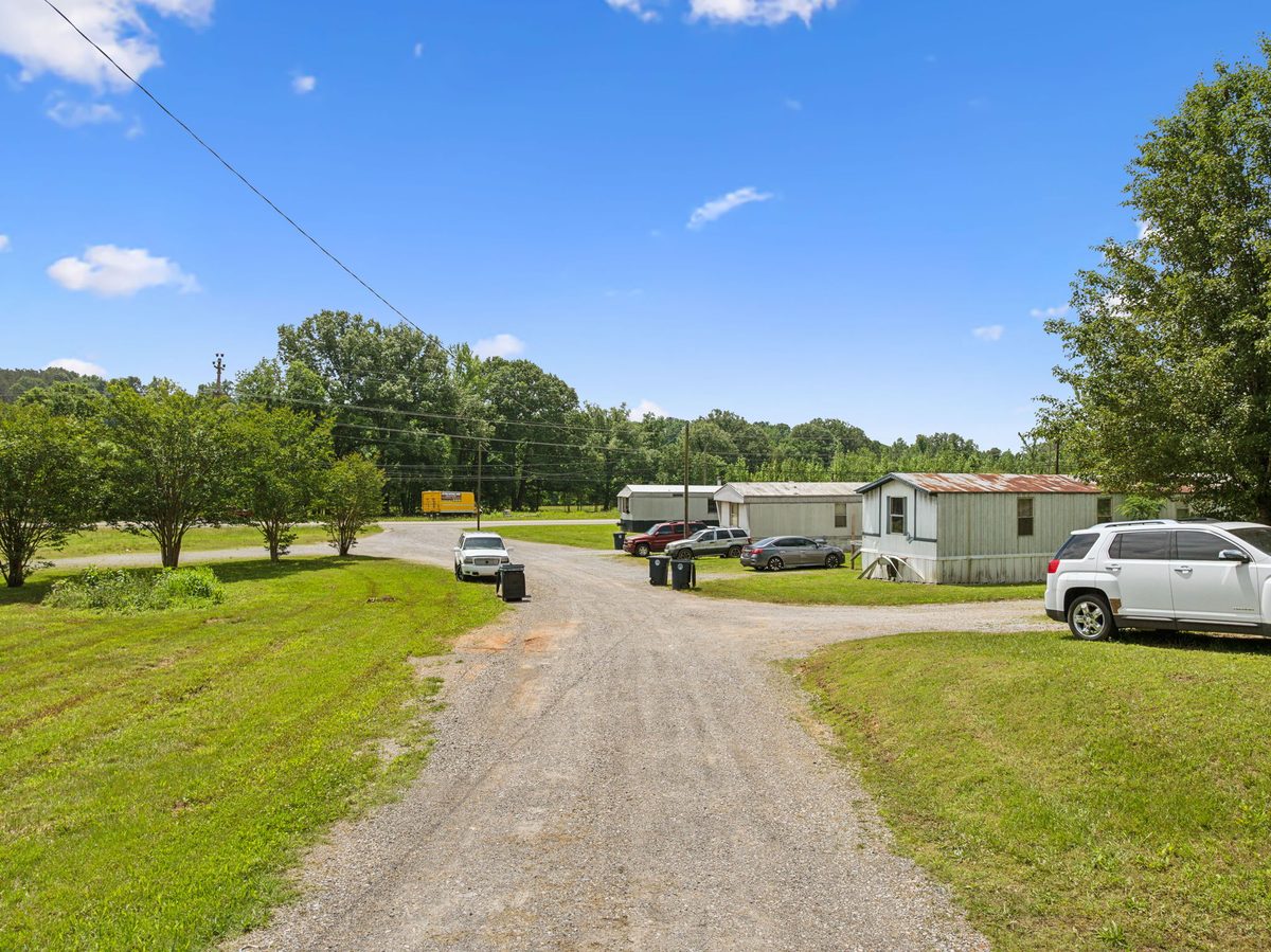 Community drive with homes and resident vehicles