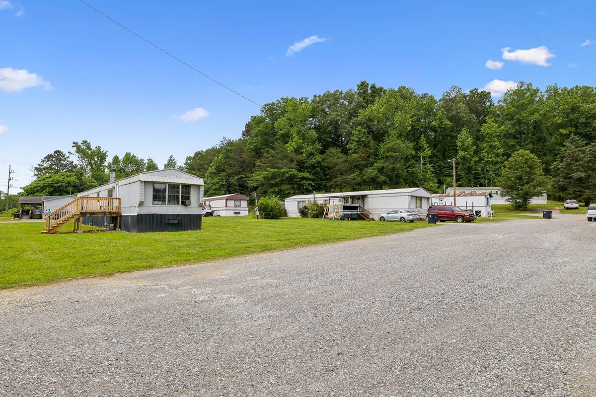 Gravel drive through the community with homes on both sides