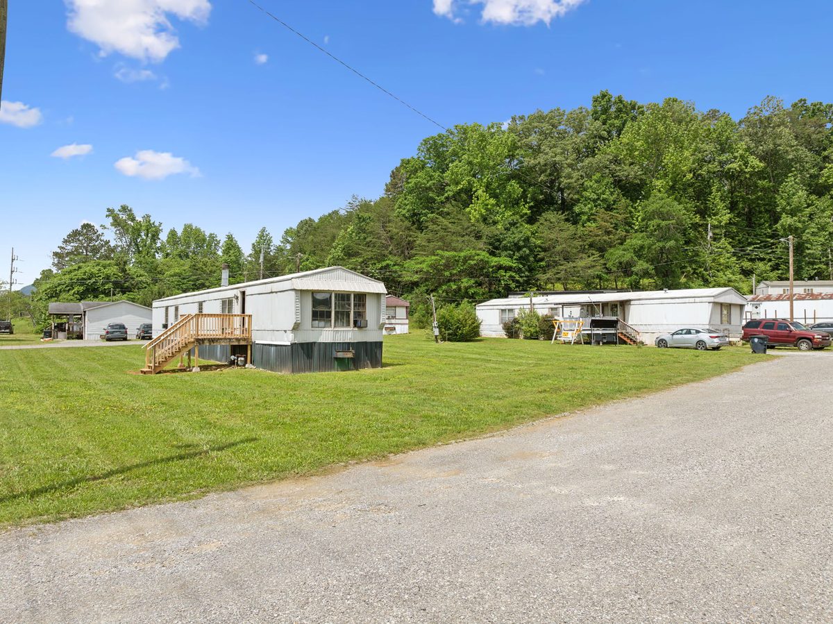 Park-owned home beside the community's gravel lot