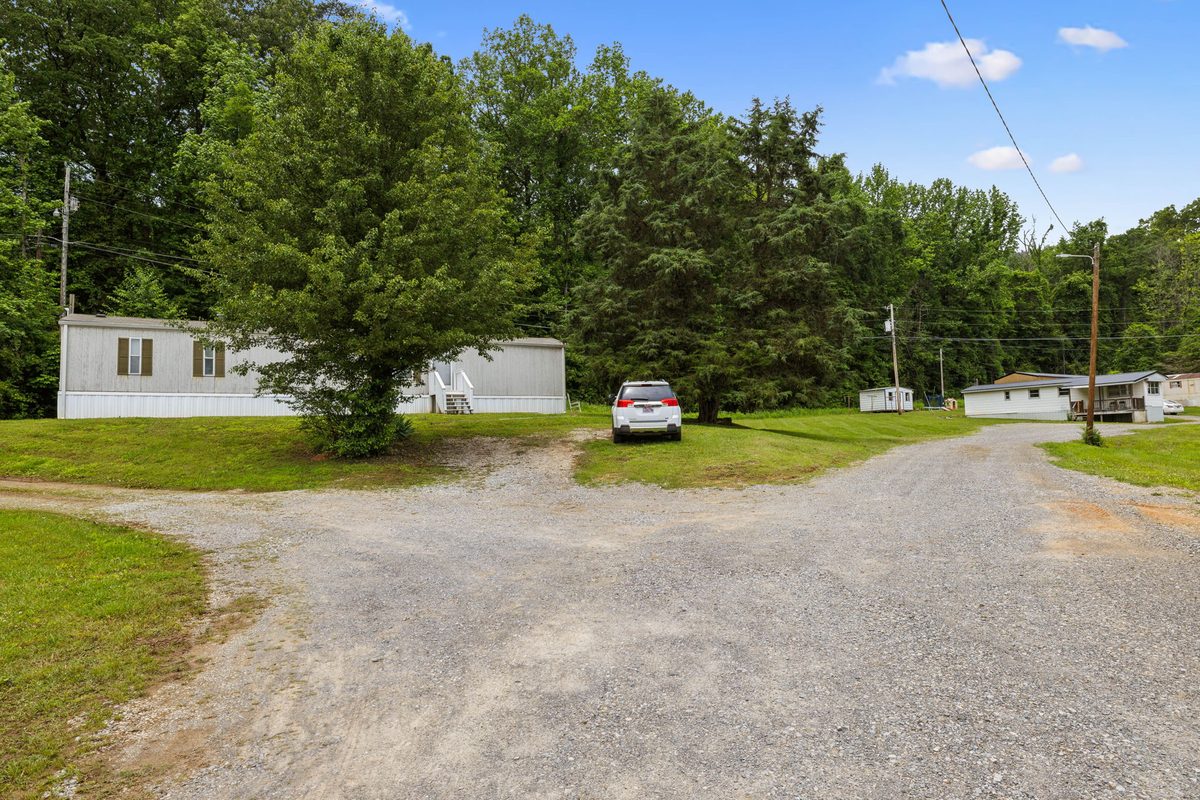 Homes along the gravel loop drive at the rear of the community
