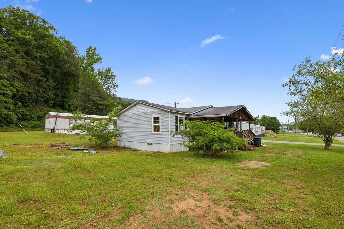 Homes with the wooded hillside rising behind the community